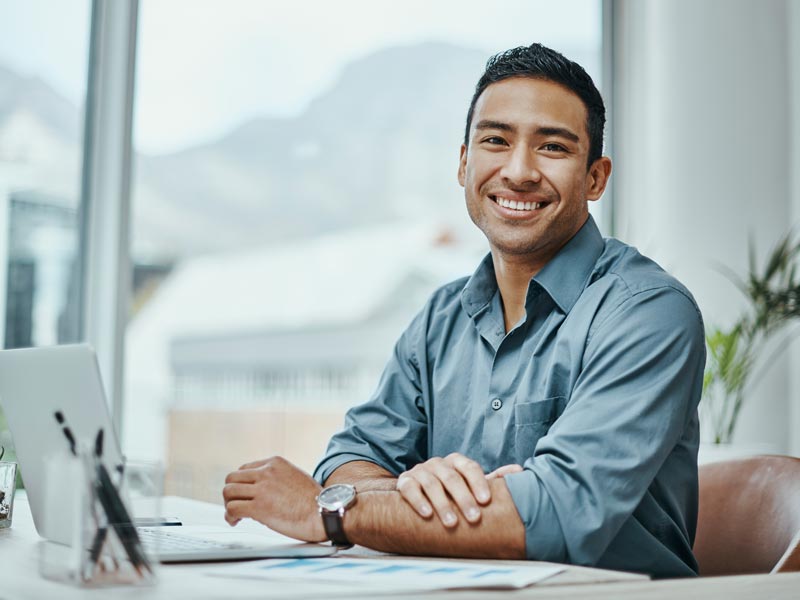 Shot of a young businessman using a laptop in a modern office