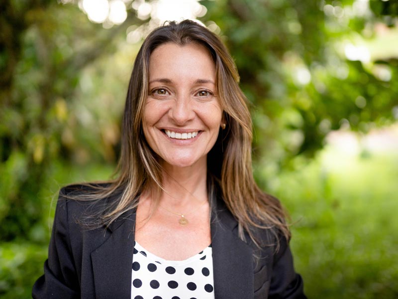 Mature woman standing outside in a park and smiling